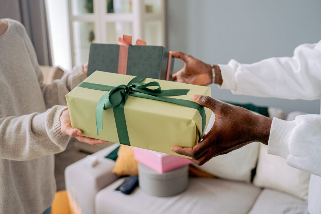 two people exchange gifts