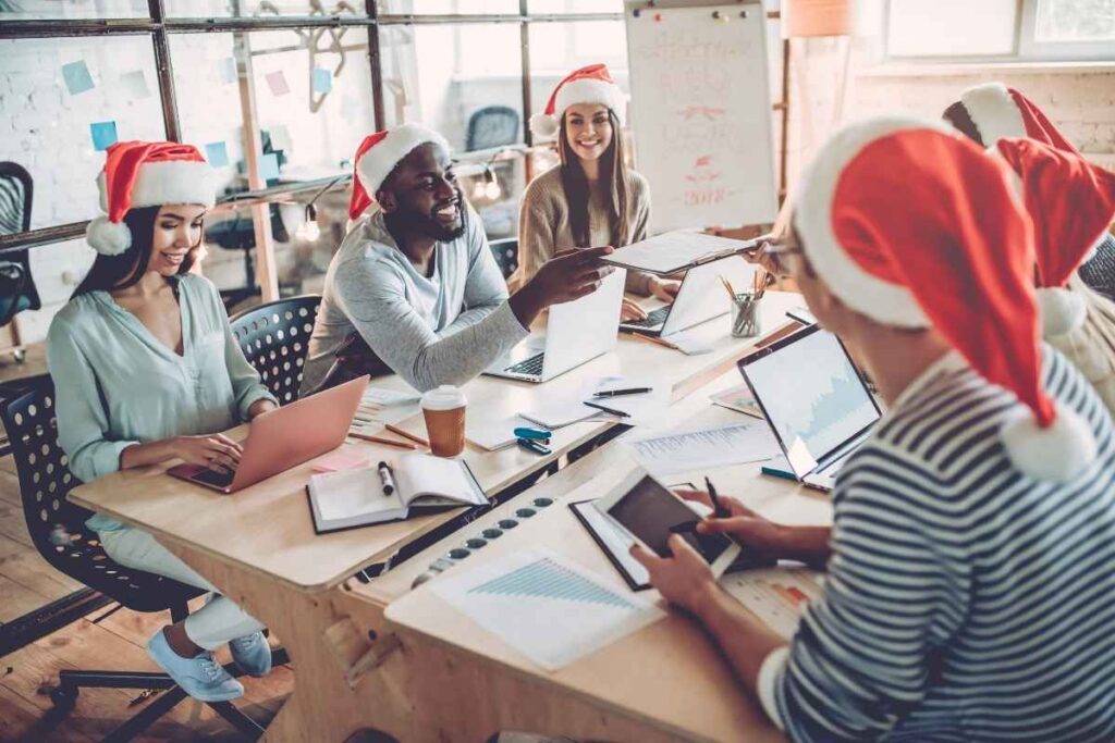 A team have a meeting in Santa hats