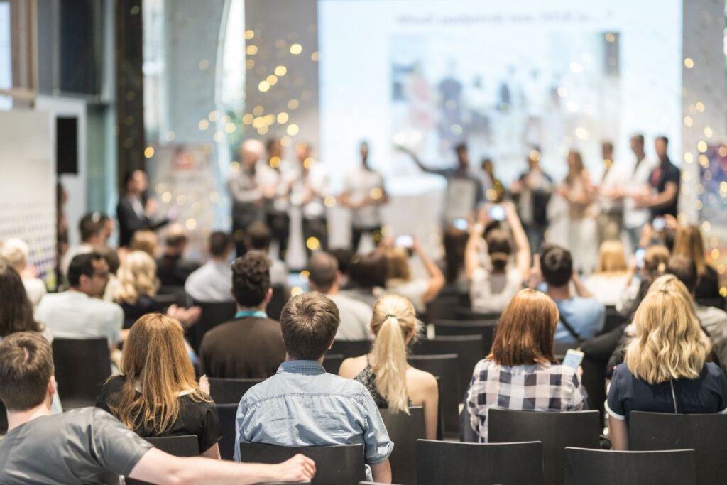 a group of people sat in the audience of a corporate awards event.