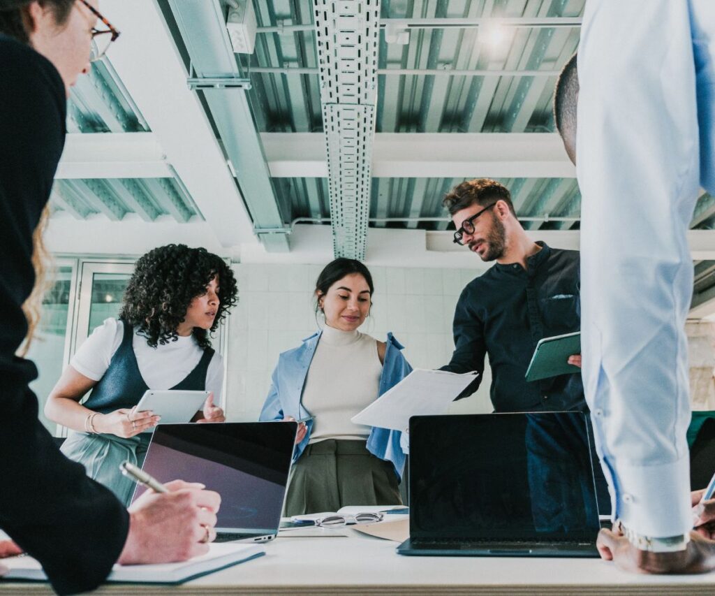 a group of colleagues collaborate in a meeting 