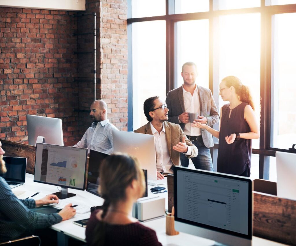 A group of colleagues collaborate together in an office.