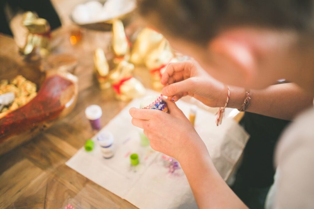 A woman takes part in an Easter craft activity at work