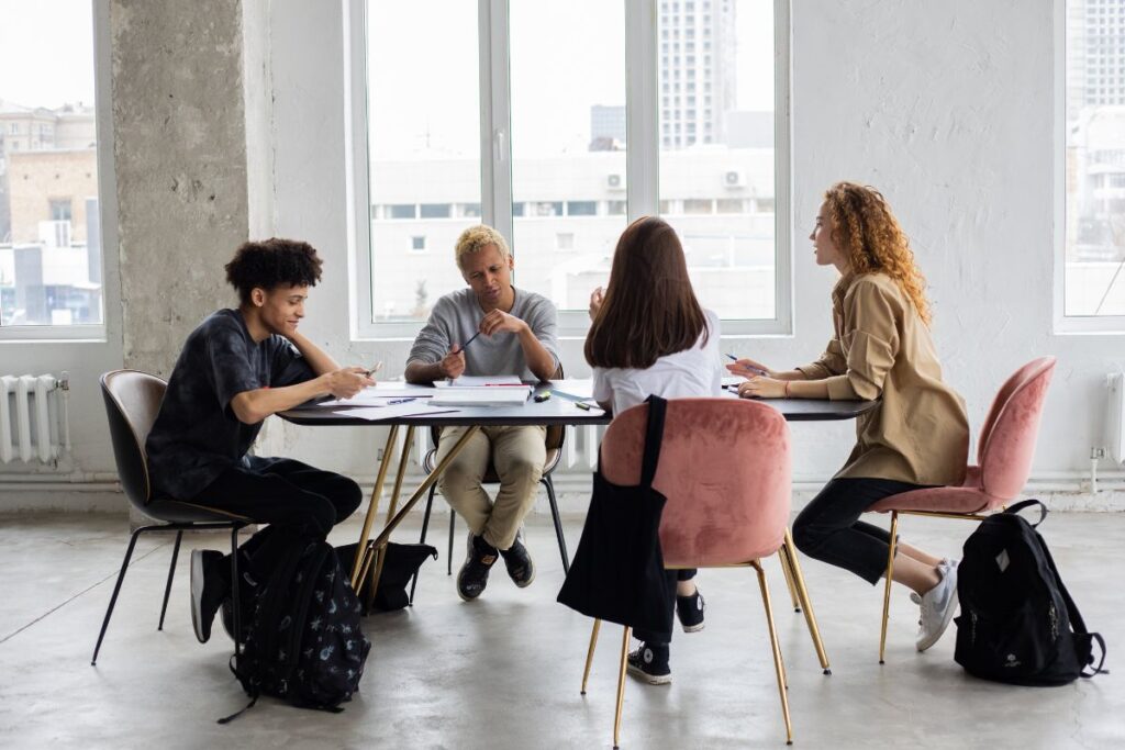A group of co-workers sit together at a meeting.