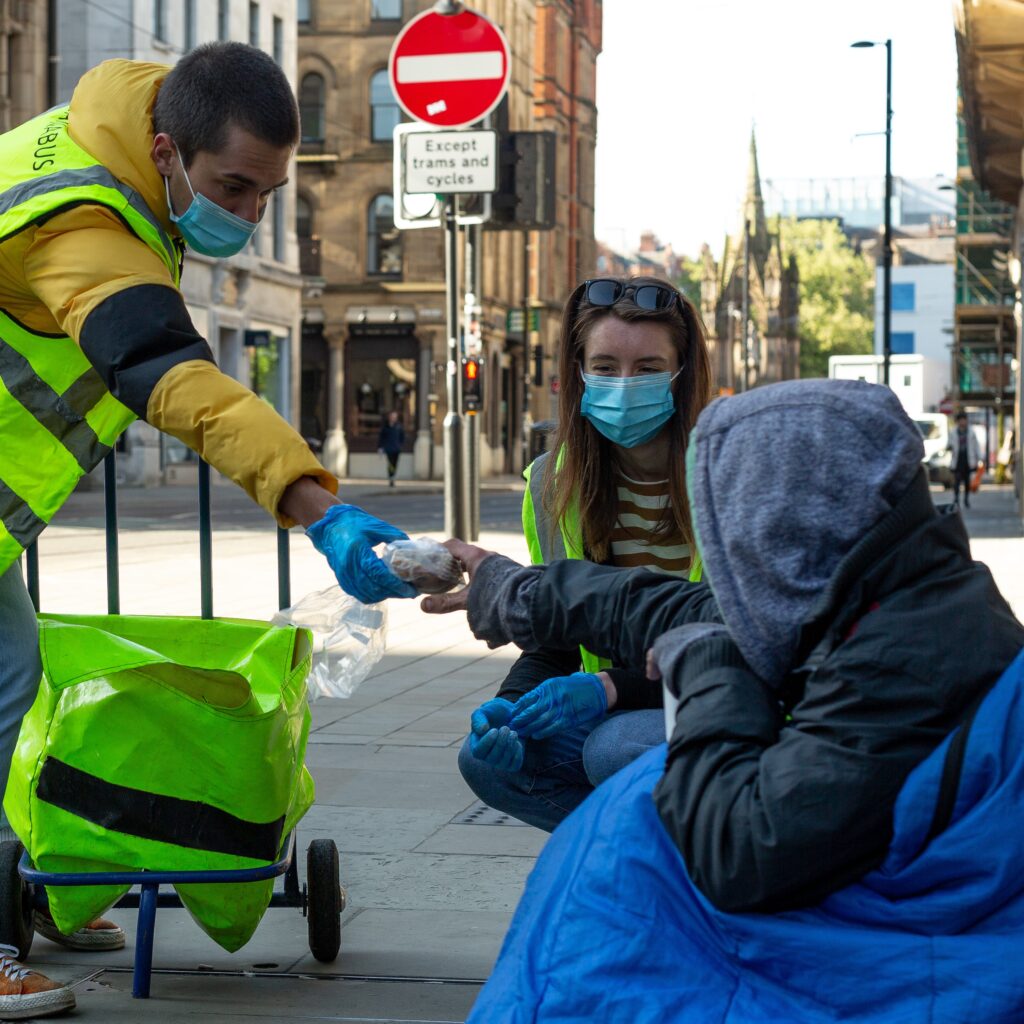 Barnabus Charity volunteers give out food to homeless people in Manchester.