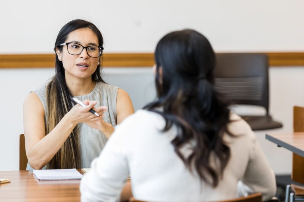 Two female coworkers it in a performance management review