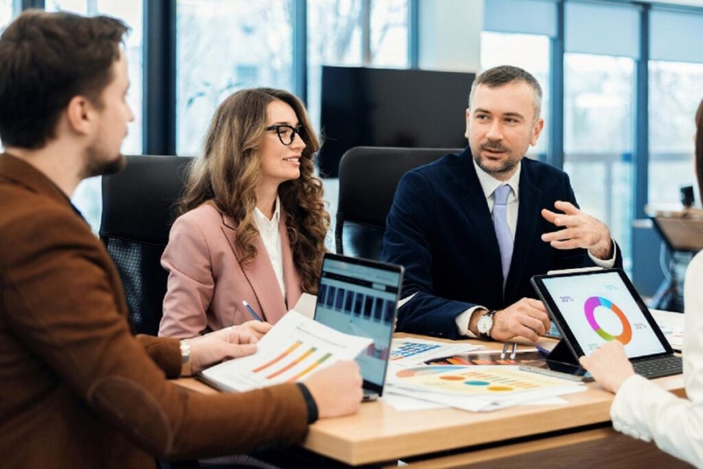 A marketing team discuss AMB strategy in a meeting.