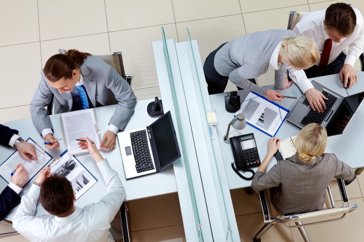 A birds-eye view perspective of an office where meetings are taking place.