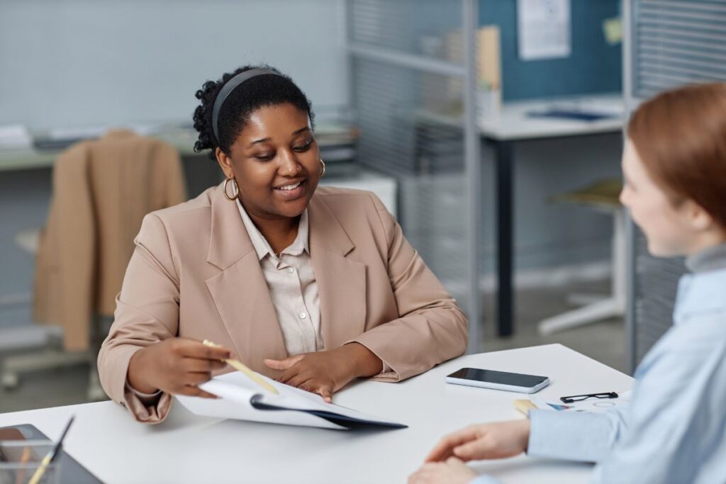 A HR professional conducts a meeting with a team member.