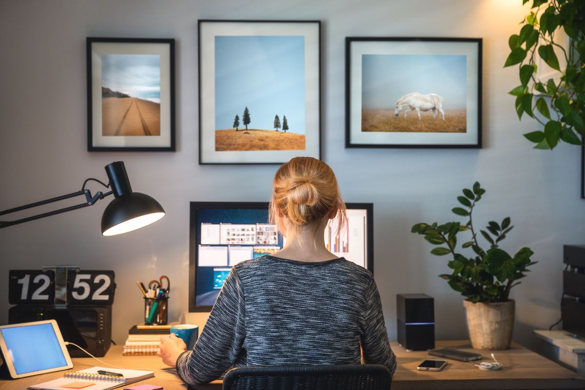 A woman sits at her desk and works from home.