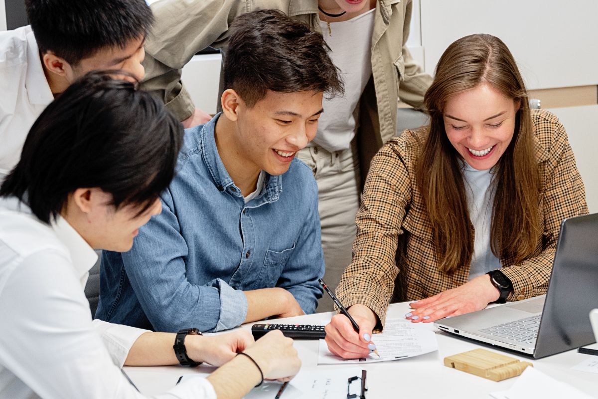 A group of people sit in a client meeting