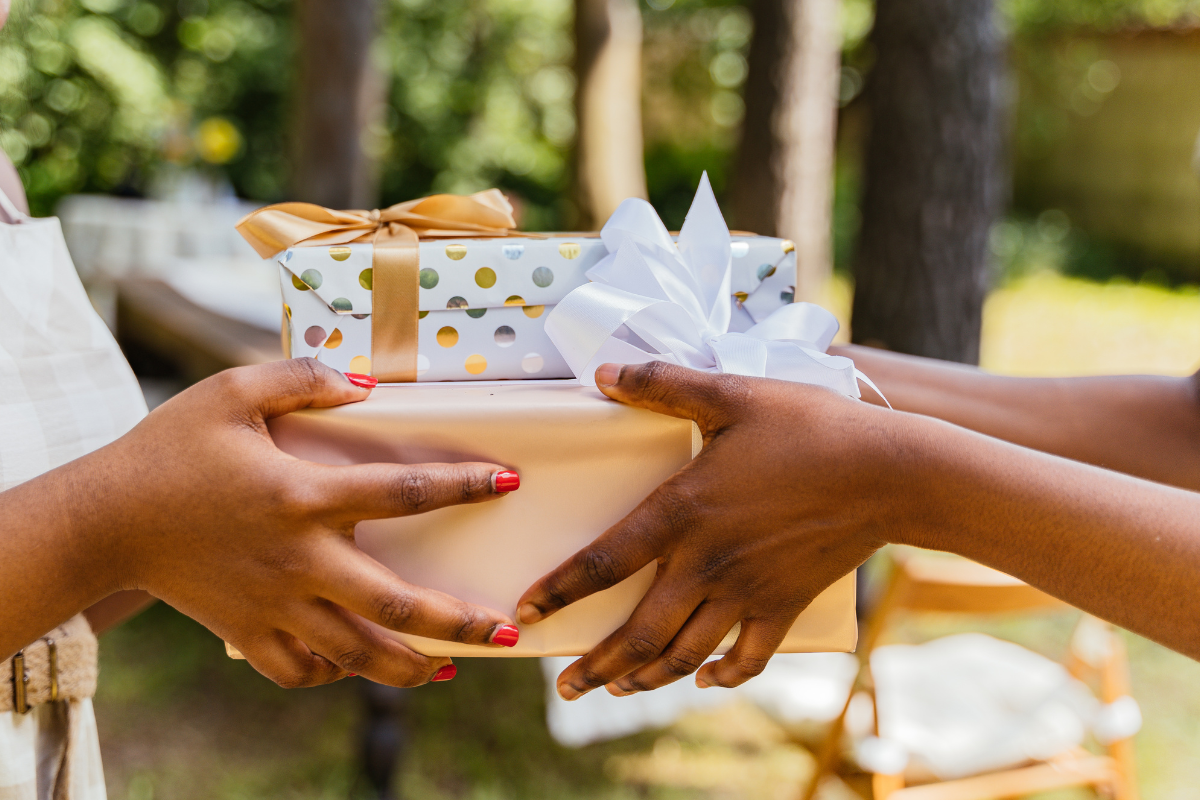 Two people exchange gifts at a wedding
