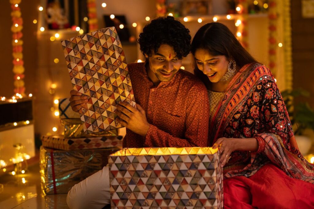 A couple open a gift during their Diwali celebrations