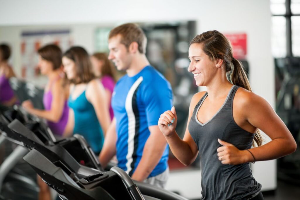 A group of employees run on treadmills together as part of a wellness initiative.