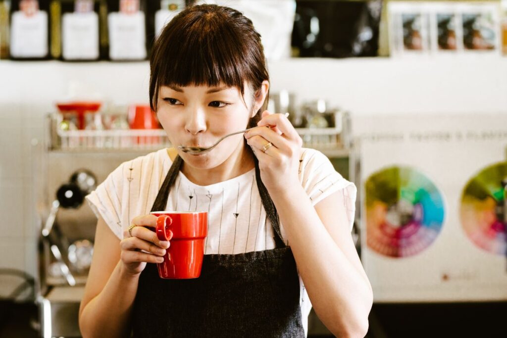 A woman enjoys a coffee tasting experience in place of a classic Christmas work party
