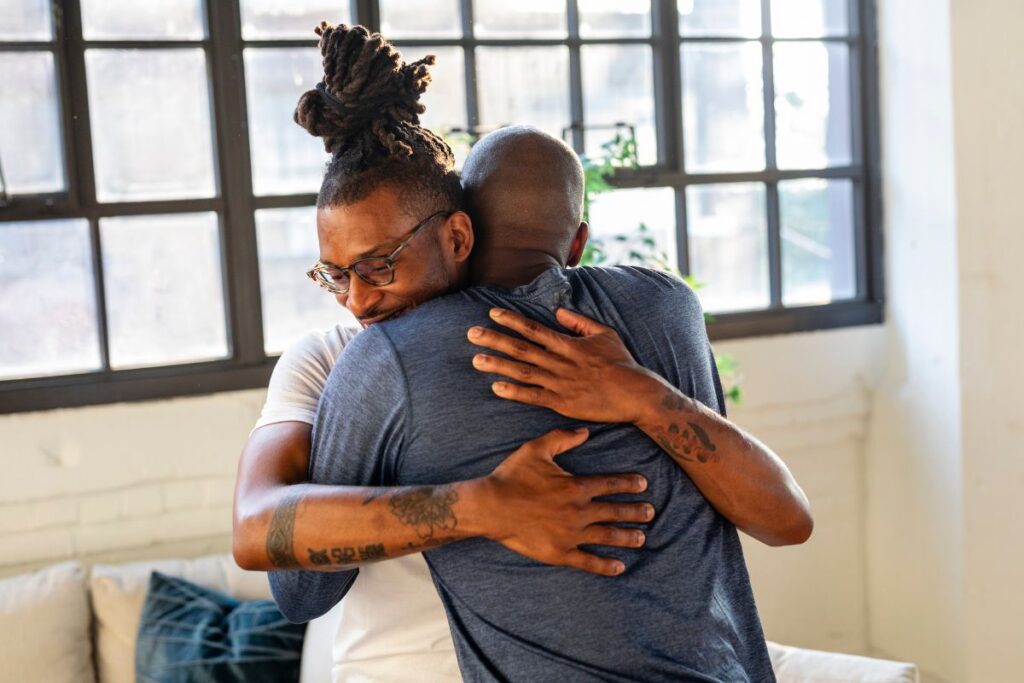 Two men hug in a meeting