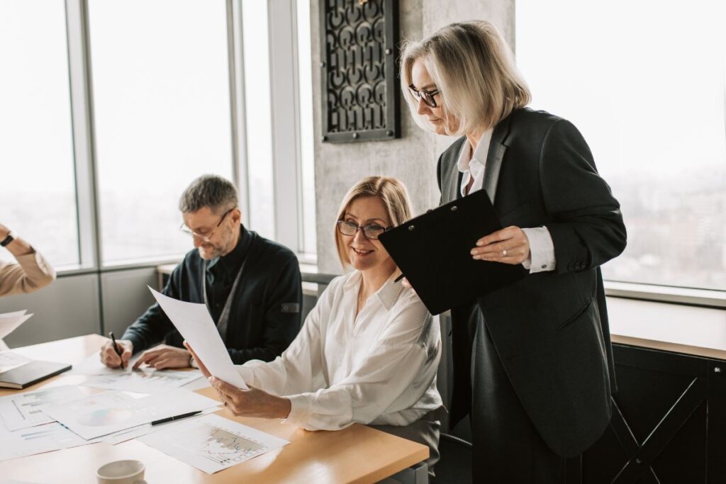 a group of three employees work together on a project