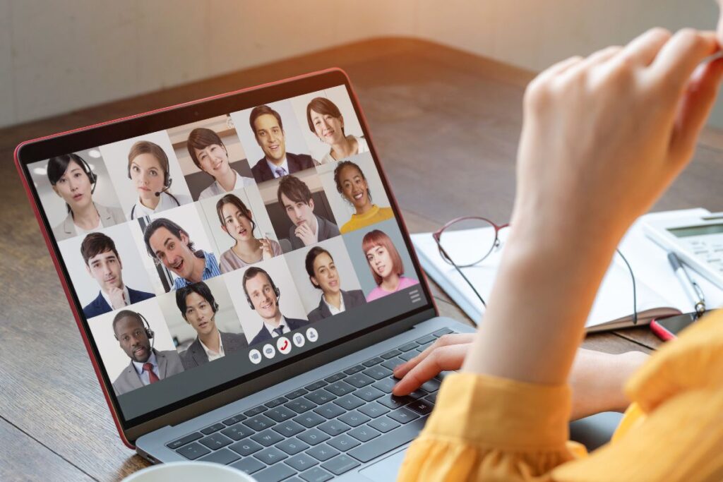 An employee works remotely and sits in a team zoom call. 