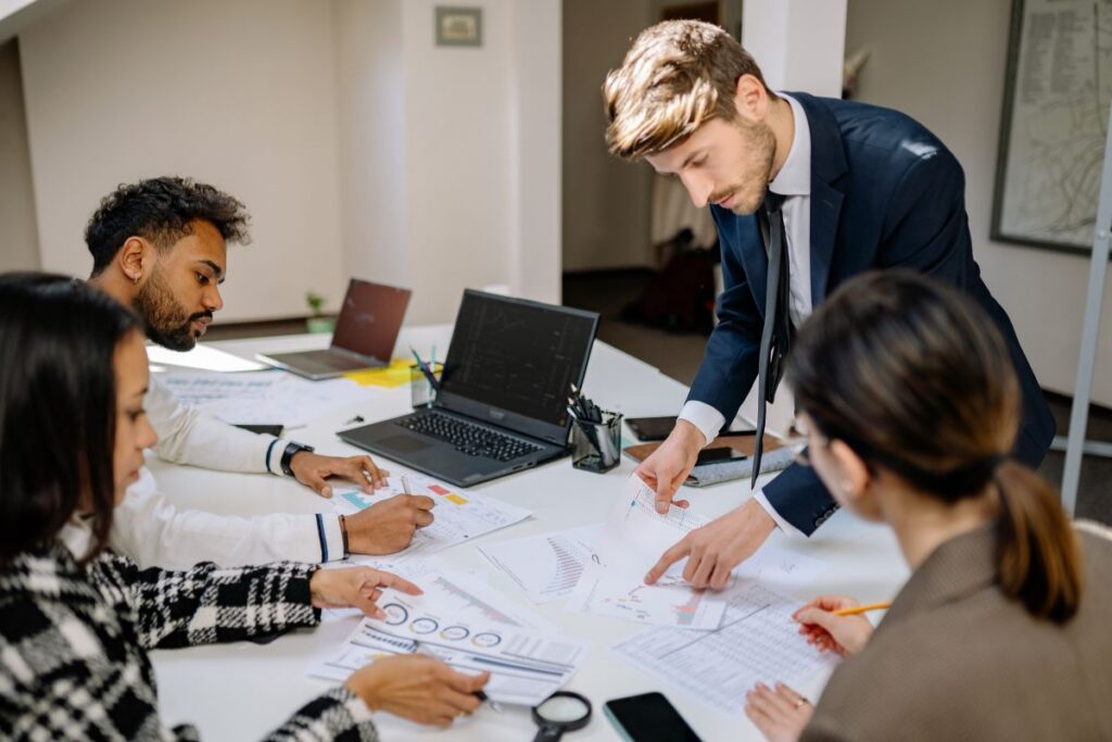 A finance team discuss left over budget in a meeting 