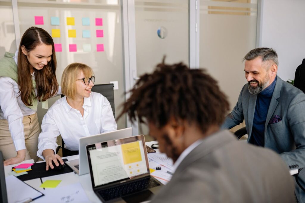 A group of employees work together in a meeting